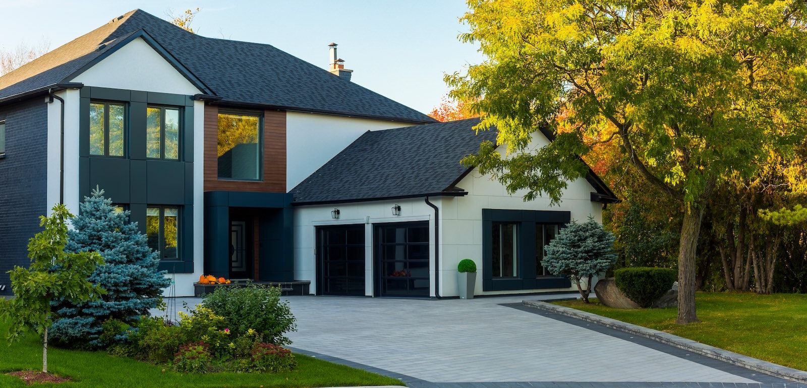 Two-story home with a wide driveway and mature trees