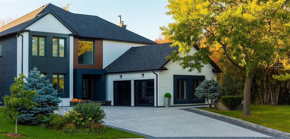 Two-story home with a wide driveway and mature trees